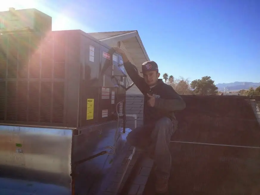 HVAC technician performing AC Tune-Up on a rooftop unit in Yorkshire